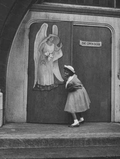 Scanned from Yasuhiro Ishimoto’s 1948-1989 retrospective photobook. black woman and church door with angel painted on