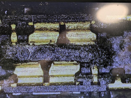 Pre-op microscope photo of the fucked-up FPC. Total image width is perhaps 1/12" / 2mm