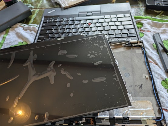 A disassembled X230 lid with a loose LCD in the foreground