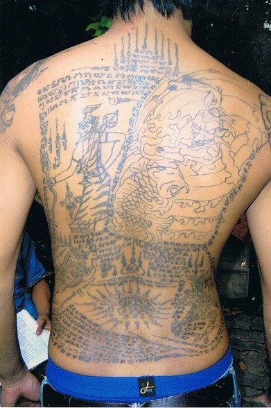 back covered in elaborate tattoo