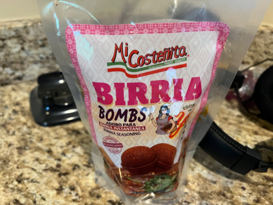 The front of a "Birria Bombs" bag that holds two birria bombs.  It's made by _Mi Costeñita_.