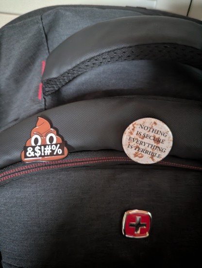 Poop emoji pin for enshittification and button that reads Nothing is secure Everything is terrible