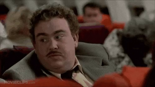 John Candy from the movie Planes, Trains, and Automobiles nodding his head in agreement and saying "Oh sure, sure."