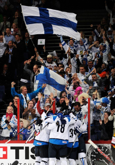 Finnish fans and team celebrating on icehockey arena