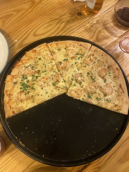 A shrimp pizza on a 16 inch steel pan