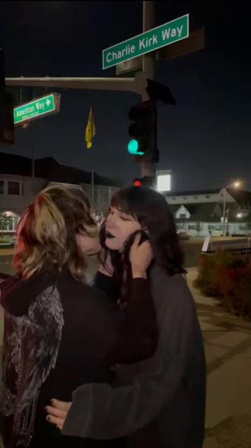 lesbians kissing in front of charlie kirk way sign