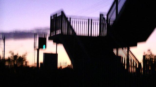 a blurry snap of a railway footbridge sihlouete with a green light signal thingy against purple orange sky. from last week tho. i forgot to toot it last week.
i know...i spelt sihlouete wrong, i just can't be bothered today. you know how it is.