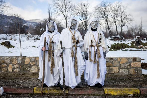 white robes and stone faces roped