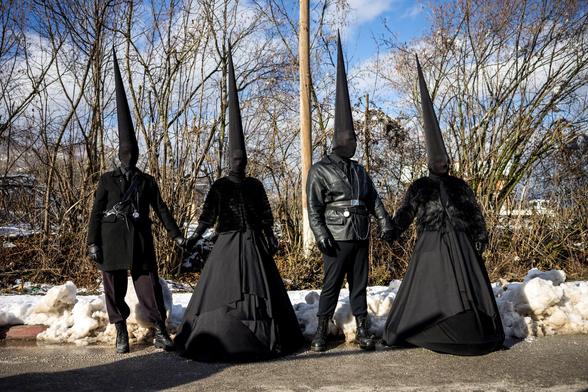 4 revelers in pointy black outfits