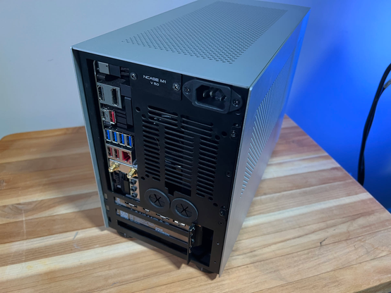 A picture of the rear of the NCASE M1 V5 case that houses the Steam Machine knock-off.  A ton of ports are available, but evidently not the IO shield because the builder was being very, very lazy and wasn't worth tracking it down.
