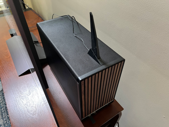 The custom Steam Machine installed behind the TV in the living room.