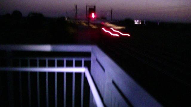 view from railway footbridge at night with train lights. blurr,  