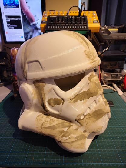 Picture is a Star Wars helmet on a desk with still a whole lot of sanding and painting to do.