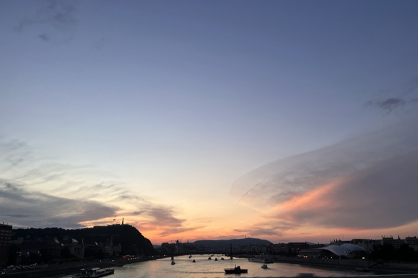 Sunset sky, river, boats.