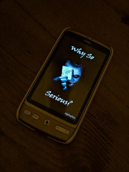 HTC Desire booting showing a custom S-OFF splash screen depicting the Heath Ledger Joker holding a card with a picture of the Android logo and the text S-OFF with top and bottom text "Why so serious?"