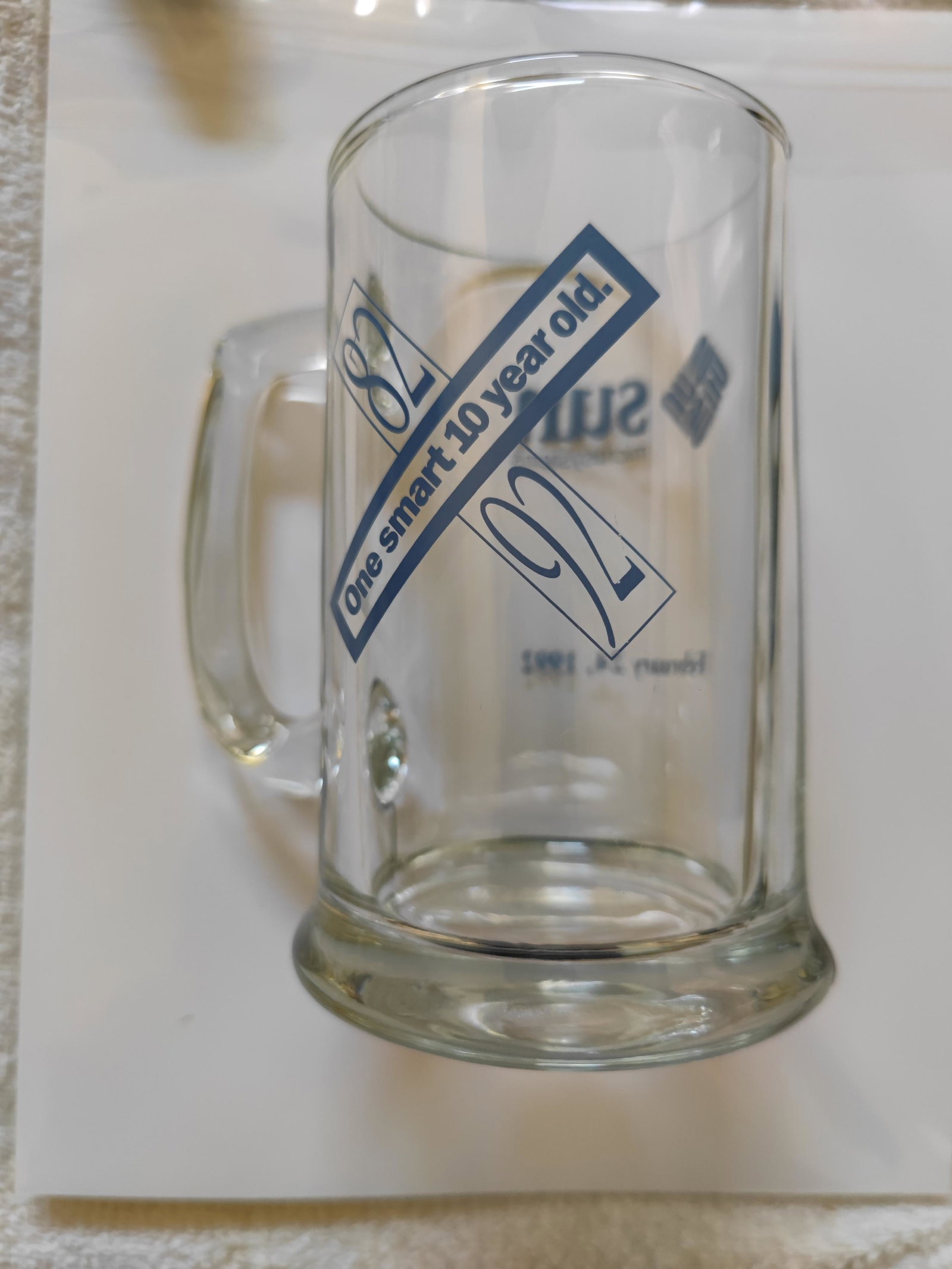 Sun Microsystems glass stein from 1992. It says "One smart 10 year old." And 82 92 in blue lettering