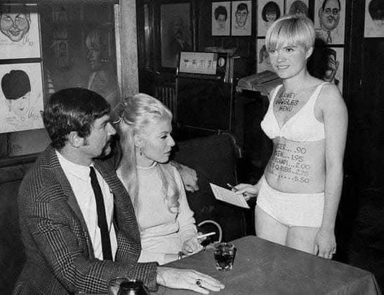 A 1968 marketing stunt at "Barney Google's," a bar and restaurant on East 86th Street in New York City. The waitress served as a "human menu" with daily specials and prices written directly on her body in black marker.