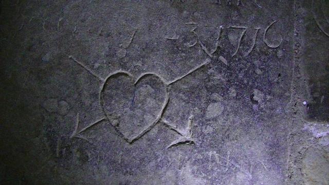 a tombstone i spotted on the floor of the church. most of the inscription is mostly worn away. it bears a carving of a heart ♡ with two arrows shot through in an X shape. And a date "-3  1716"
beauty and sadness.