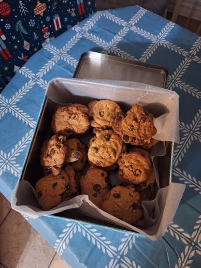 Forty freshly baked chocolate chip cookies for work in a tiny.