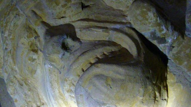closeup of a carved head on a corbel.