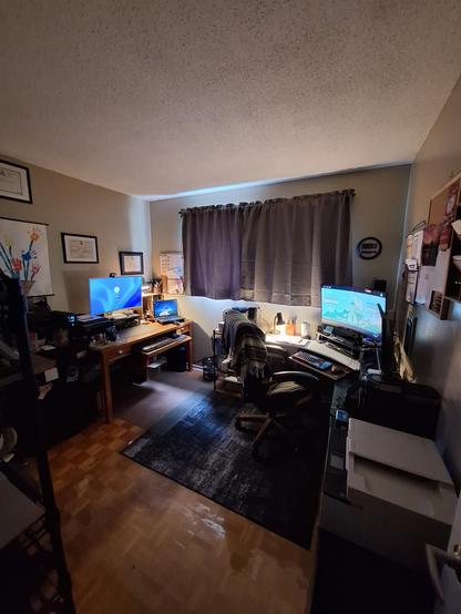 Left side is personal mini computer and laptop.  Right is work machine.  Bottom right is printer/scanner and coffee maker. This home office.