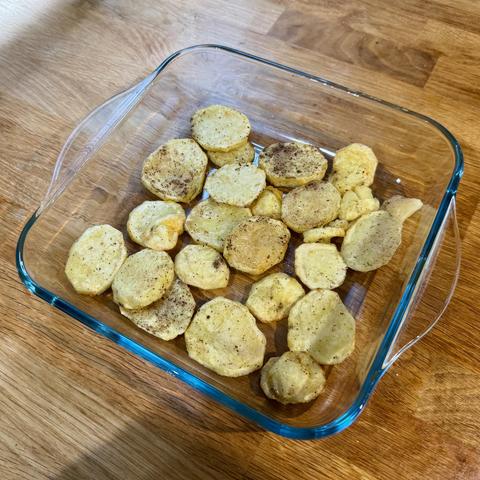 First stage: air-fried potato slices covering the bottom of the oven dish