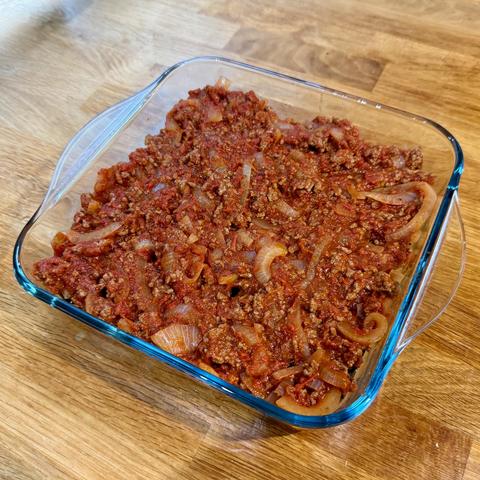 Then tomato, meat and onion sauce covering the eggplants