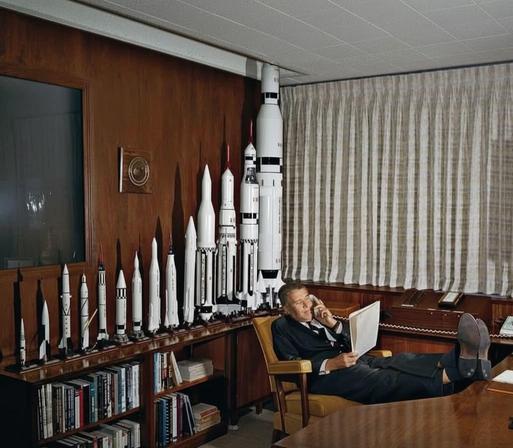 von braun in his american office with rocket models in the back, feet up on the desk