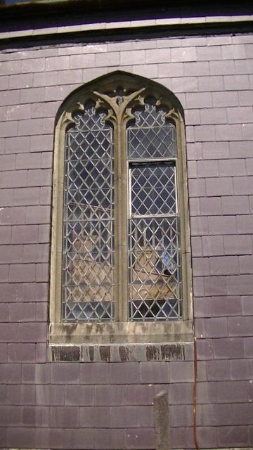 another window south wall of St.Ffraid's church from the other week. the wall is covered in slate tiles prolly from when the church was restored 19th century. it is a leaded arched window. the side of the wooden upper story of stepped pews is visible through the window starting a little way up. there has been a church there since the 12th century but only the font survives from that period. the tower and i guess the other parts date back 16th century. i should toot a snap of the font. i will do…
