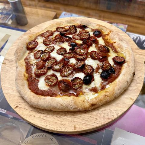 Pizza with basic tomato sauce base, mozzarella and roasted cherry tomatoes on top